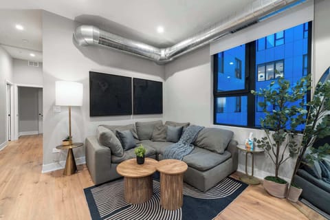 Open living area w/ comfy seating, clean lines & soft lighting for easy evenings in