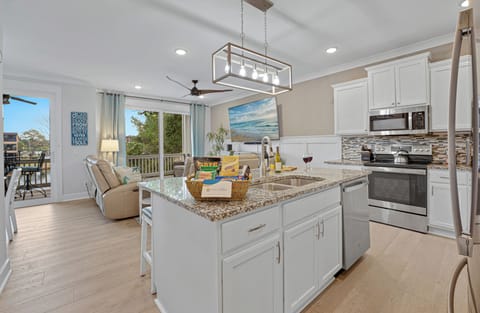 Seamlessly connected with kitchen and dining areas it is designed for socializing in style.