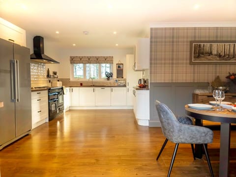 A wider shot of the large, modern kitchen featuring extensive counter space and high-quality appliances.
