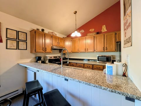 Fully equipped kitchen with bar stools