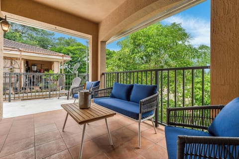 Massive 3rd-floor balcony with outdoor seating and green views