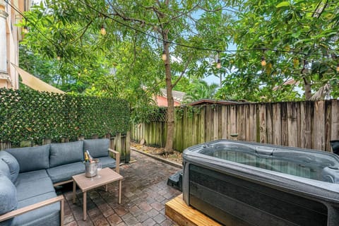 Private backyard with hot tub and lush greenery
