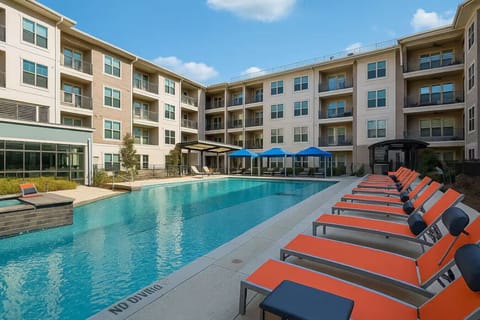 - Resort style pool with sun loungers and private cabanas - Luxury apartment community with outdoor relaxation space - Sparkling swimming pool perfect for vacation vibes