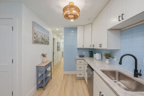 Open entryway leading to a fully equipped kitchen.
