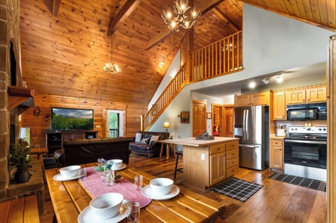 Bright, open-plan living, kitchen, and dining with stunning cabin charm