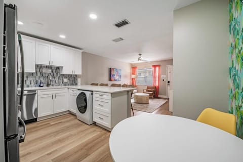 Open-concept layout with a modern kitchen, bright dining nook, and cozy living area. Enjoy sleek appliances, warm lighting, and vibrant accents—perfect for gathering, cooking, and relaxing in style.