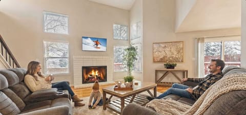 Spacious, sun-filled living area with a warm fireplace, comfy seating, and room for everyone to unwind