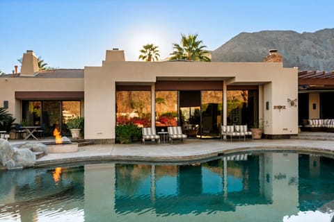 A serene desert retreat where modern elegance meets mountain views, complete with a private pool and tranquil outdoor living space.