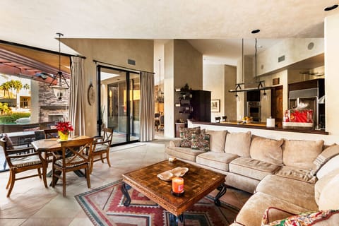 A seamless blend of comfort and functionality, featuring a cozy seating area, dining table, and open sightlines to the patio. Large sliding doors enhance the indoor–outdoor flow, making it perfect for entertaining.