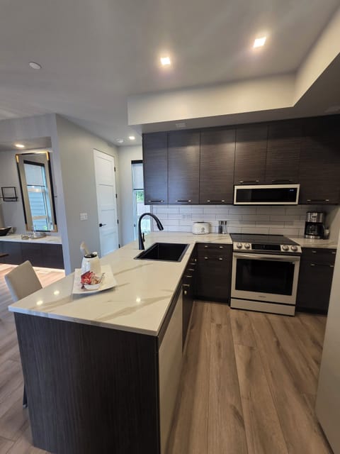 Chef's Kitchen. Higher end appliances and dishware. Bar seating.