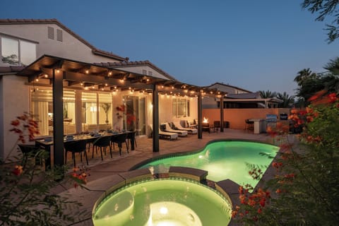 Resort-Style backyard wit heated pool and spa glowing at dusk-your own private 
