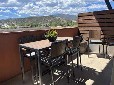 Balcony with outdoor dining and views