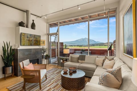 Living room with view, fireplace, balcony