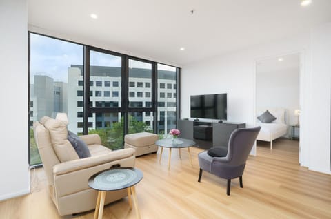 A sunlit lounge featuring a calming palette and panoramic windows invites you to sit back, relax, and enjoy the view.