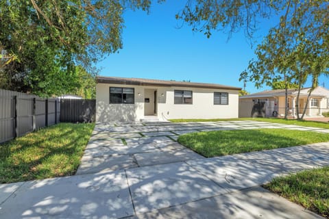 Welcome to this bright and modern single-story home, featuring a clean contemporary exterior and a spacious driveway that makes parking a breeze. Surrounded by lush greenery and set on a quiet street.