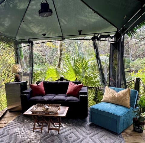 Glamzebo #1 with comfortable couch and chair sitting on the St. Lucie River