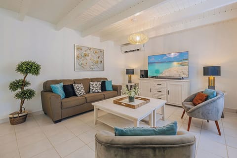 Bright and comfortable living room with seating for relaxing after the beach