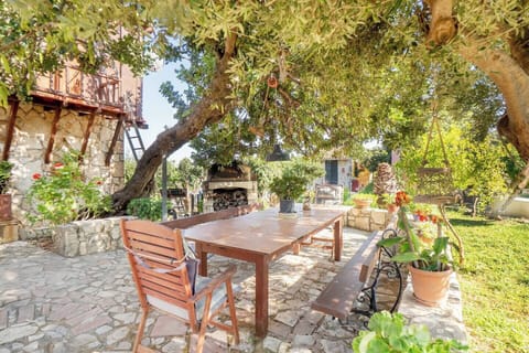 Morning coffee under the olive trees—your private garden seating oasis