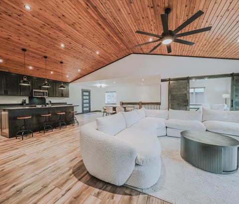 Open living area with Smart TV, large sectional, and lake views 