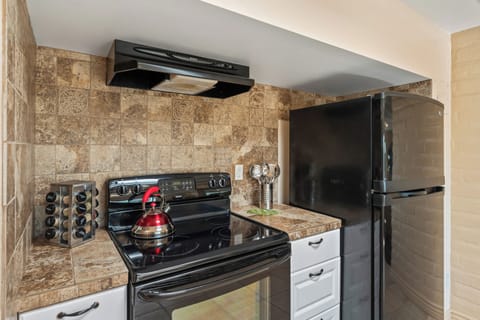 A clean, fully stocked modern kitchen.