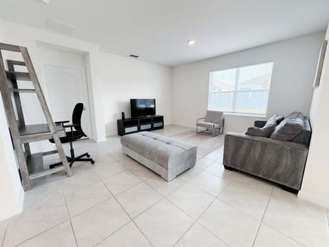 Spacious, sun-lit living room.