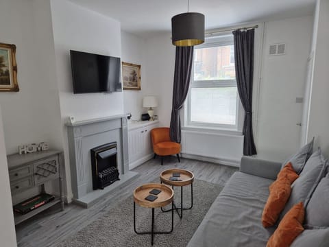 Light-filled lounge with TV and electric fireplace