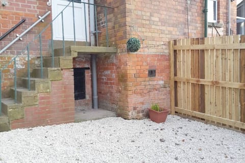 Enclosed outdoor space with steps to kitchen
