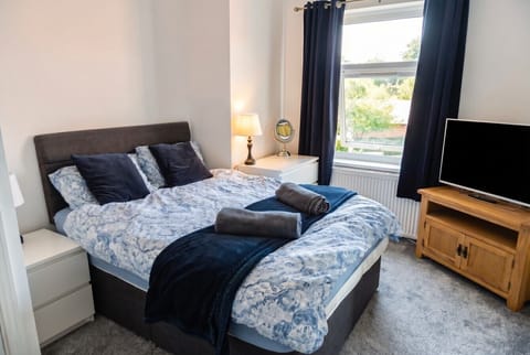 Rear double bedroom with garden view, smart TV and soft linens.