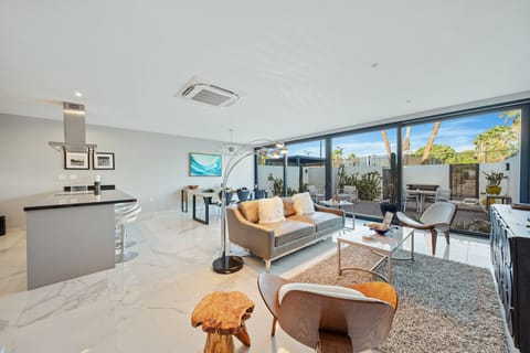 Enjoy a bright, open living space with a fully equipped kitchen and private patio — perfect for relaxing, dining, and spending time together after a day at the beach.