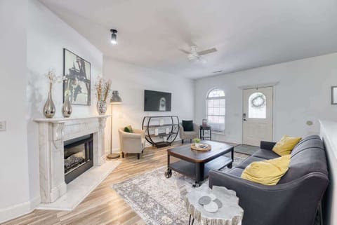 Living room with plush sofa, accent chairs, and smart TV—gather here to stream shows or share stories after a day out.