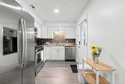 Stylish, fully equipped kitchen with sleek appliances and granite counters.