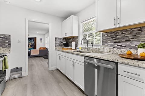 Well-equipped kitchen with granite workspace and polished stainless features.