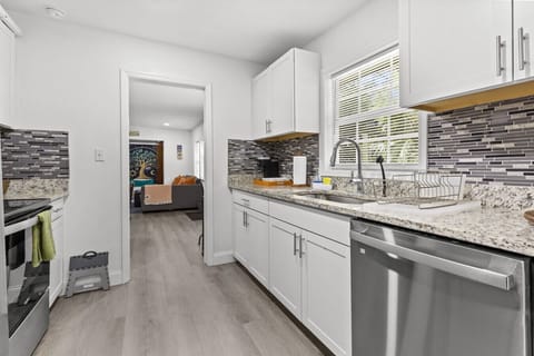 Fully equipped kitchen with stainless steel appliances and granite counters.