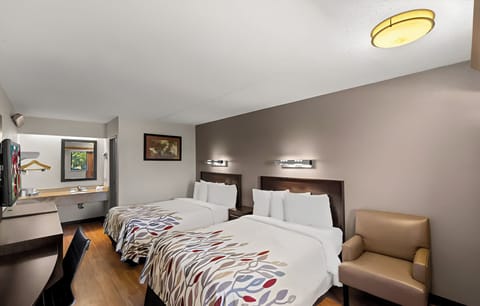 Unwind in a spacious double‑bed room with cozy seating.
