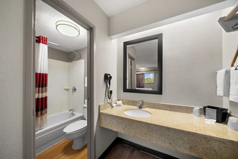 Freshen up at a roomy vanity with bright, even lighting.