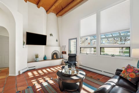 living room featuring rustic wood beams, a cozy fireplace, and comfortable seating where you can unwind after exploring the area.