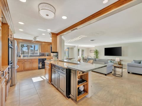 Fully Stocked Open Kitchen and Comfortable Family Room Layout