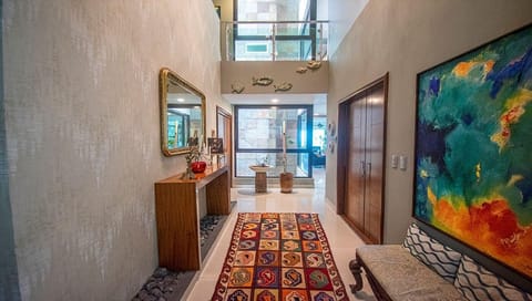 Spacious entryway with vibrant art and natural light