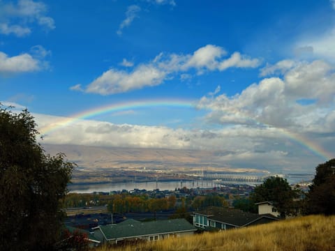 View from the deck: rainbows, barges, river, twinkly city lights.