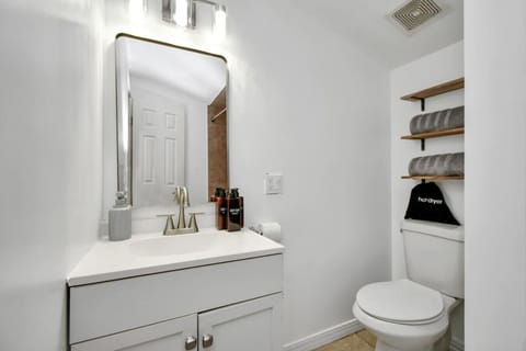 Freshen up in the modern bathroom, featuring a walk-in shower and sleek, updated fixtures for your convenience.