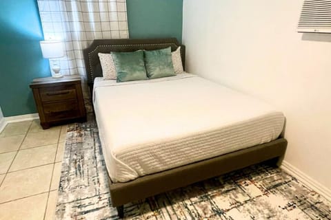 Rest in comfort on a queen-size bed with plush linens and thoughtful touches, designed for a peaceful night`s sleep