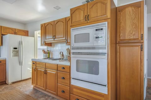 Fully stocked kitchen with ample cabinetry and full-size appliances.