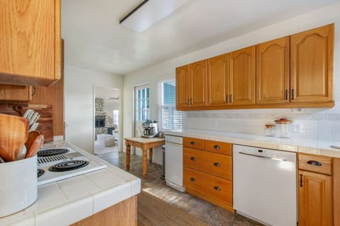 Fully stocked kitchen with generous cabinetry and essential cookware.