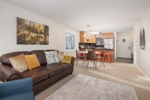 Sink into the plush leather sofa and enjoy your spacious open-plan living area, where modern kitchen meets cozy comfort.