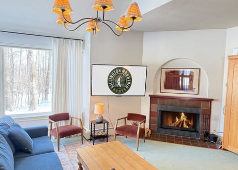 Gather and relax in a warm space featuring a classic fireplace.