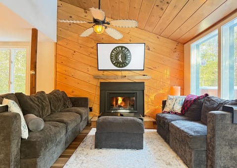 Warm fireplace, comfy seating, and a TV for your downtime.