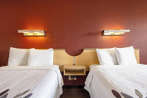 Drift off in fresh bedding with warm bedside lighting.