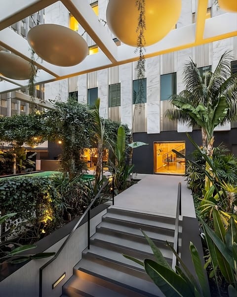 Step into a sunlit atrium oasis with resort-style calm.