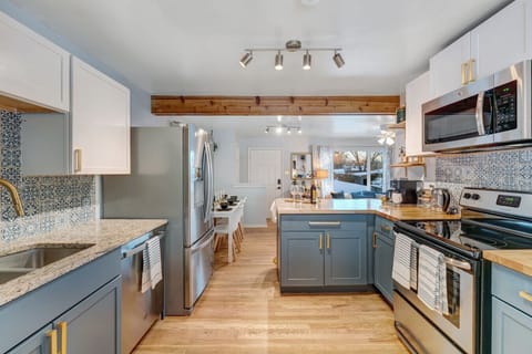 Cook with ease in this newly updated kitchen—full-size stainless appliances, bold backsplash, and stocked essentials await.