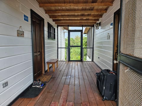Screened breezeway connecting both sides of the house.